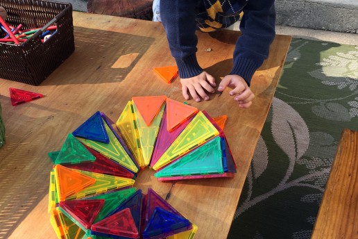 Building with Magna Tiles in the Yard